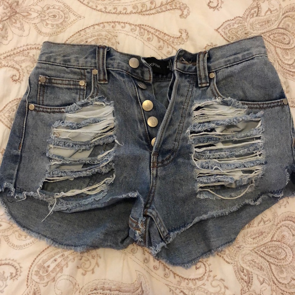 mink pink shorts with rips on the front